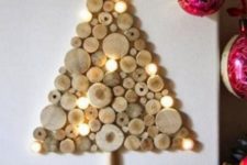 02 a wall-mounted wood slice Christmas tree with lights is a great rustic idea that brings coziness