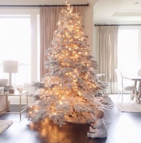a large flocked Christmas tree with lights – you don’t need any ornaments for a gorgeous and fairy tale look