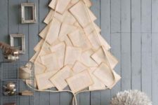04 a wall-mounted Christmas tree of vintage book pages and some rope plus a frame on top of it or book lovers