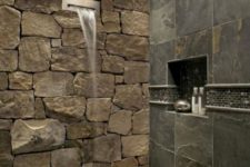 08 a gorgeous contemporary shower done with a natural stone wall, wall tiles imitating stone and a waterfall shower