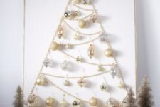 11 a Christmas tree sign made of pearly and silver ornaments and a pearl garland for a glam space