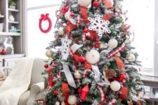 11 a gorgeous red and white Christmas tree with pinecones, metallic ornaments and large red gift boxes