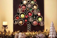 12 a colorful Christmas tree of PVC pipes and bright ornaments and pinecones inserted into them for decor