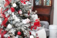 13 a flocked Christmas tree decorated with plaid ribbons, fabric blooms, white ornaments and other decor