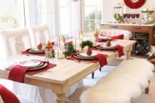14 a chic Christmas dining room with burgundy napkins and pillows, touches of white fur and candles