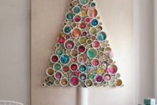 18 a PVC pipe Christmas tree with various ornaments and toys inside is a cool idea for a bright modern space