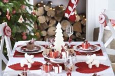 18 a modern red and white Christmas table setting, red and white ornaments and stockings and a tree decorated in the same colors