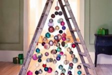 20 a ladder with ornaments hanging from it looks colorful and industrial and is a whimsical decor idea