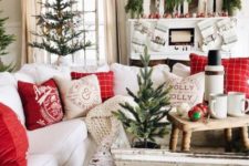 20 a red and white Christmas living room with printed pillows, red and white ornaments and some natural trees