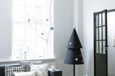 21 a paper Christmas tree in black and white with stars on a pole is a cool idea for a monochromatic or minimalist interior