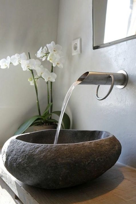 a rough and natural stone sink will give a natural and tropcial feel to your bathroom
