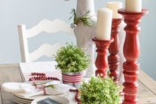 21 a simple red and white Christmas tablescape with candles, fresh greenery and cranberries in a garland