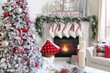 22 a super cozy and chic farmhouse space done in red and white for Christmas – with a flocked tree, stockings, printed pillows and wreaths