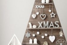 23 a plywood Christmas tree with shelves with white figurines and ornaments is rustic meets modern