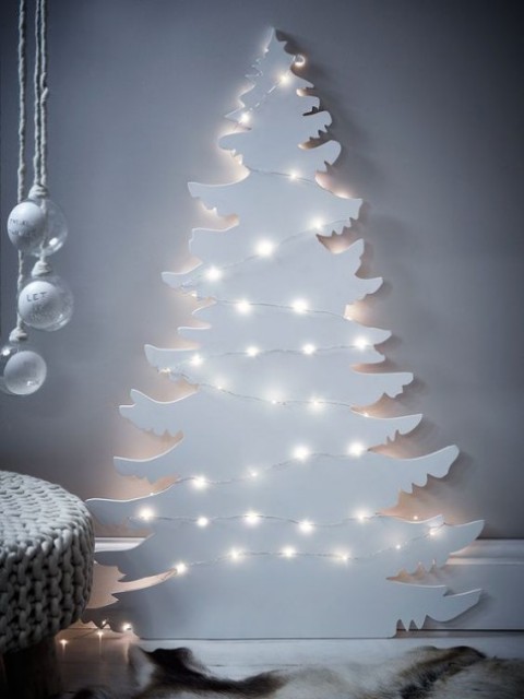 a white Christmas tree silhouette wall art with lights is great for a minimalist space or a Nordic one