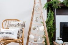 28 a wooden frame Christmas tree with white and silver ornaments hanging inside is a cool and cozy idea