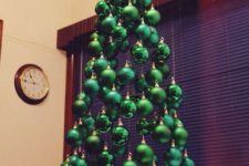 29 an arrangement of green ornaments hanging down to form a tree is a very bold idea