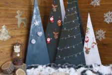 30 plywood cone and triangle Christmas trees with ornaments and lights on them is a stylish idea with a modern feel