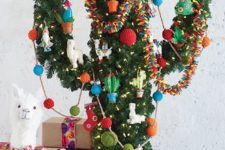 31 a cactus Christmas tree with colorful ornaments, garlands and lights and little alpaca figurines