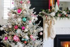 a bright flocked Christmas tree with lights, white, hot pink and neon green ornaments in a basket for a boho space