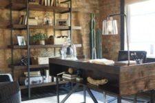a cool industrial home office with a wooden and metal desk with storage, a large shelving uni, cacti in a pot and stylish furniture