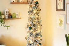 a flocked Christmas tree with lights, silver, green and gold ornaments, beads, a star on top is amazing for holiday decor
