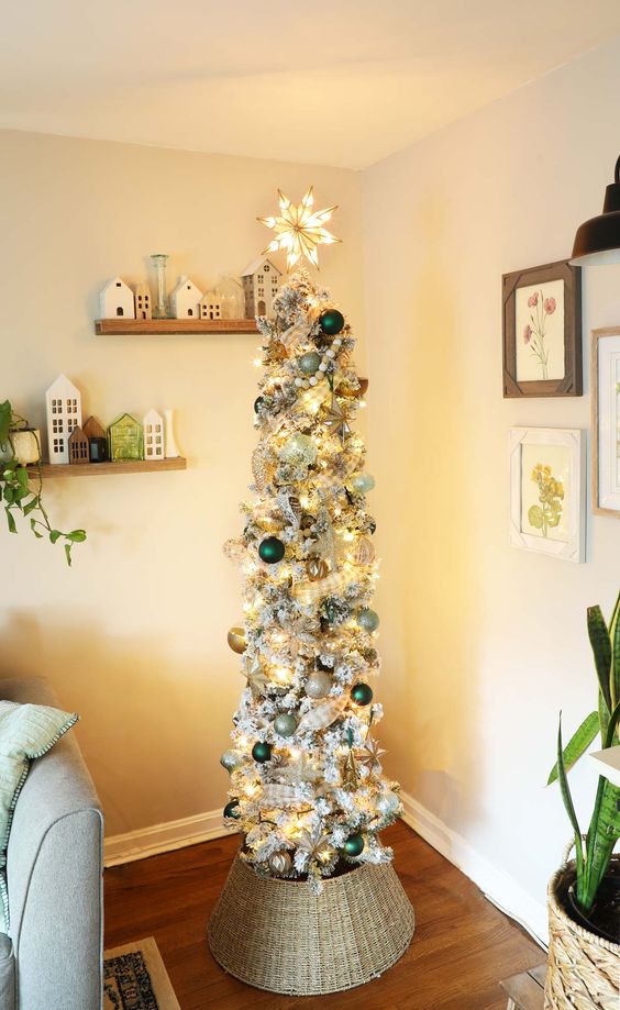 a flocked Christmas tree with lights, silver, green and gold ornaments, beads, a star on top is amazing for holiday decor