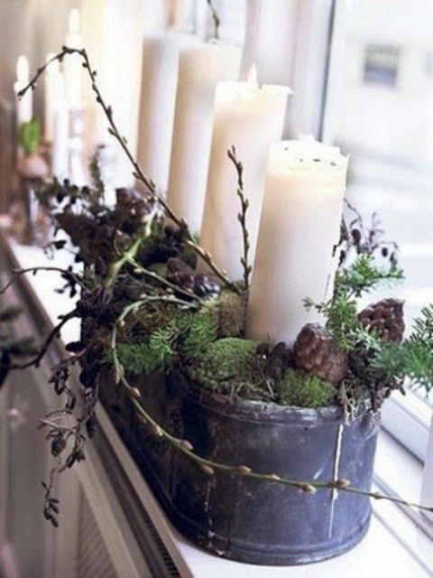 a galvanized bathtub with moss, pinecones, willow pussy and pillar candles for mantel or windowsill decor