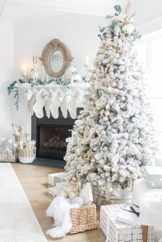 a magical flocked Christmas tree with gold, white and silver ornaments, pinecones, greenery, lights and grasses is amazing