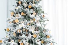 a natural Christmas tree with ornaments, citrus slices, pinecones, doilies and a star topper is amazing