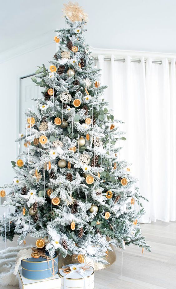 a natural Christmas tree with ornaments, citrus slices, pinecones, doilies and a star topper is amazing