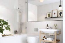 a neutral contemporary bathroom with large scale tiles, an oversized mirror and a wooden vanity