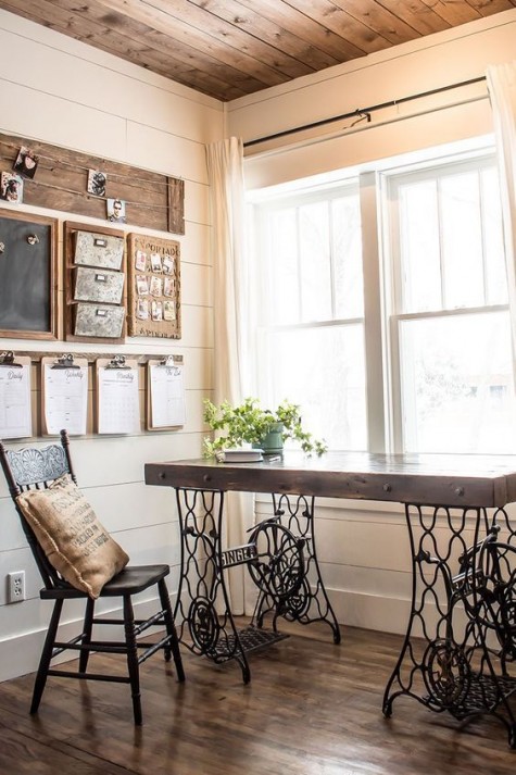 a rustic meets industrial home office with a desk made of a vintage sewing machine, a wooden note board, a vintage wooden chair