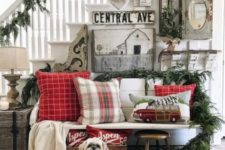 a shabby chic gallery wall, plaid pillows, evergreens and baskets for a Christmas entryway
