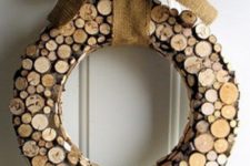 a wood slice Christmas wreath with a burlap bow is a fun and fresh take on a traditional one