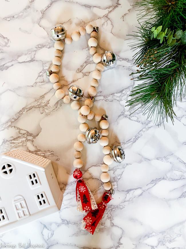 DIY wooden bead Christmas garland with bells and colorful tassels (via averageinspired.com)