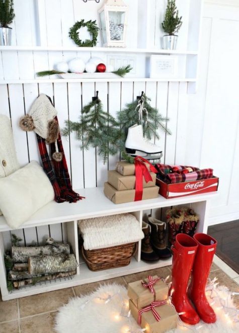 evergreens and Christmas trees in buckets, firewood, red boots, lights, gift boxes and plaid pillows for a Christmas feel