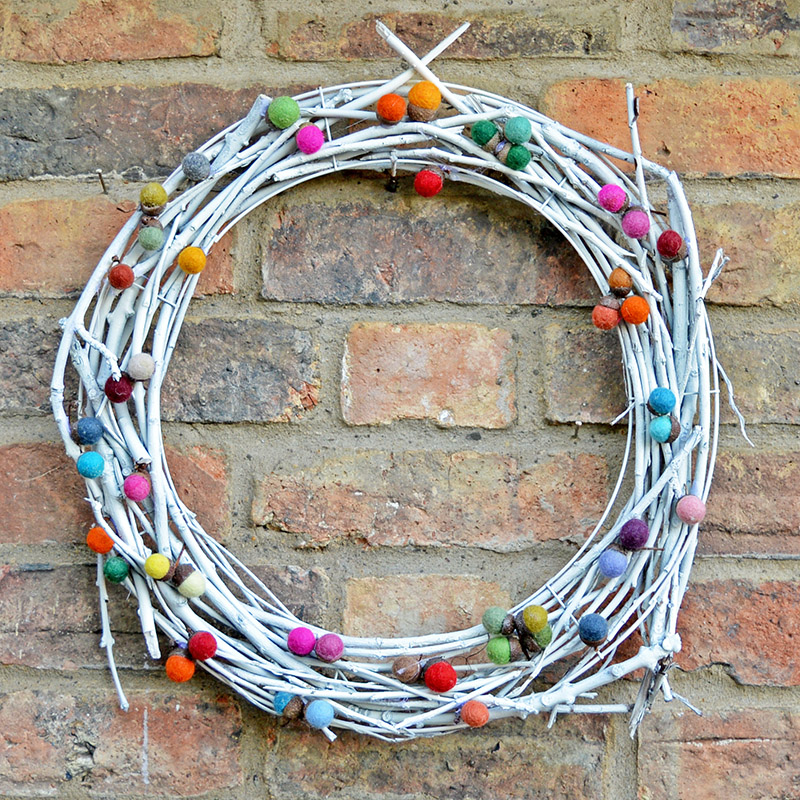 DiY whitewashed vine wreath with colorful felt balls for Christmas and not only