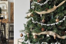 neutral rustic Christmas tree decor with pinecones, burlap ribbons, pompom garlands and aged metal ornaments