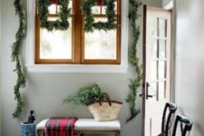 an entryway with lots of evergreen decor