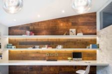 02 floating shelves with additional lights and a matching floating desk in front of a reclaimed wood wall