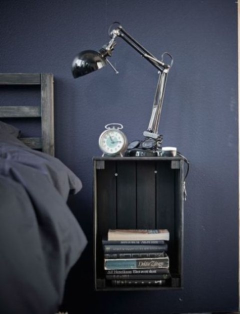 a Knagglig box painted grey and attached to the wall makes up a cool floating bedside table