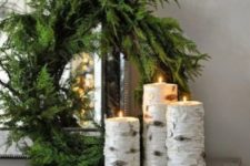 03 an evergreen wreath with birch candle holders for natural decor with a strong modern feel