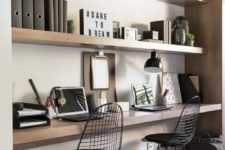 04 a minimalist home office space done with thick sleek shelves and a matching floating desk under them plus catchy black chairs