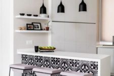 05 an all-white minimalist kitchen enlivened with bright black and white printed tiles on the kitchen island