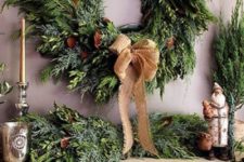 05 an evergreen wreath and garland with magnolia leaves and burlap will dress up your mantel and make it holiday-like