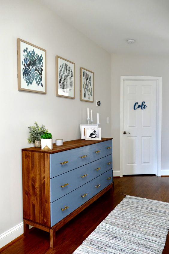a bold Tarva hack with rich-colored stain and blue paint, with brass handles for a mid-century modern space