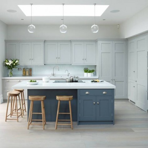 a dove grey kitchen, a slate blue kitchen island and white countertops that match to create a more unified space