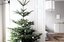 06 a minimalist Christmas tree with black and white ornaments is simple and stylish and will fit any minimalist space