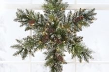06 a snowy evergreen Christmas wreath with pinecones and lights shaped as a snowflake is an original and cool idea